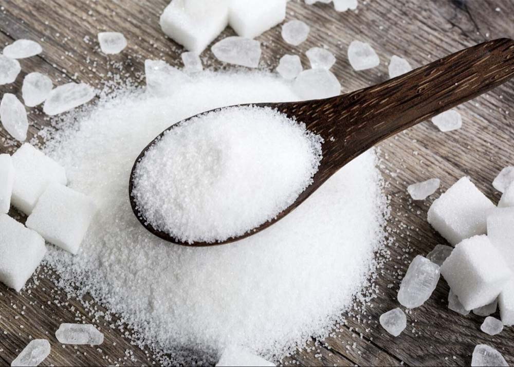 ICUMSA 45 White Sugar crystals with a wooden spoon